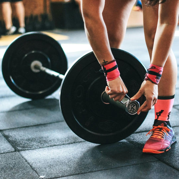 Person holding a black barbell